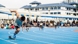 asian-runner-sprinting-on-track-from-starting-position